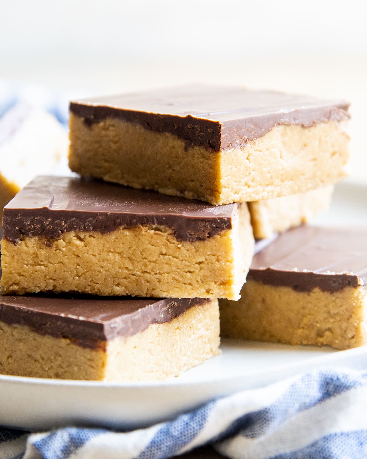 A pile of chocolate peanut butter bars on a plate.