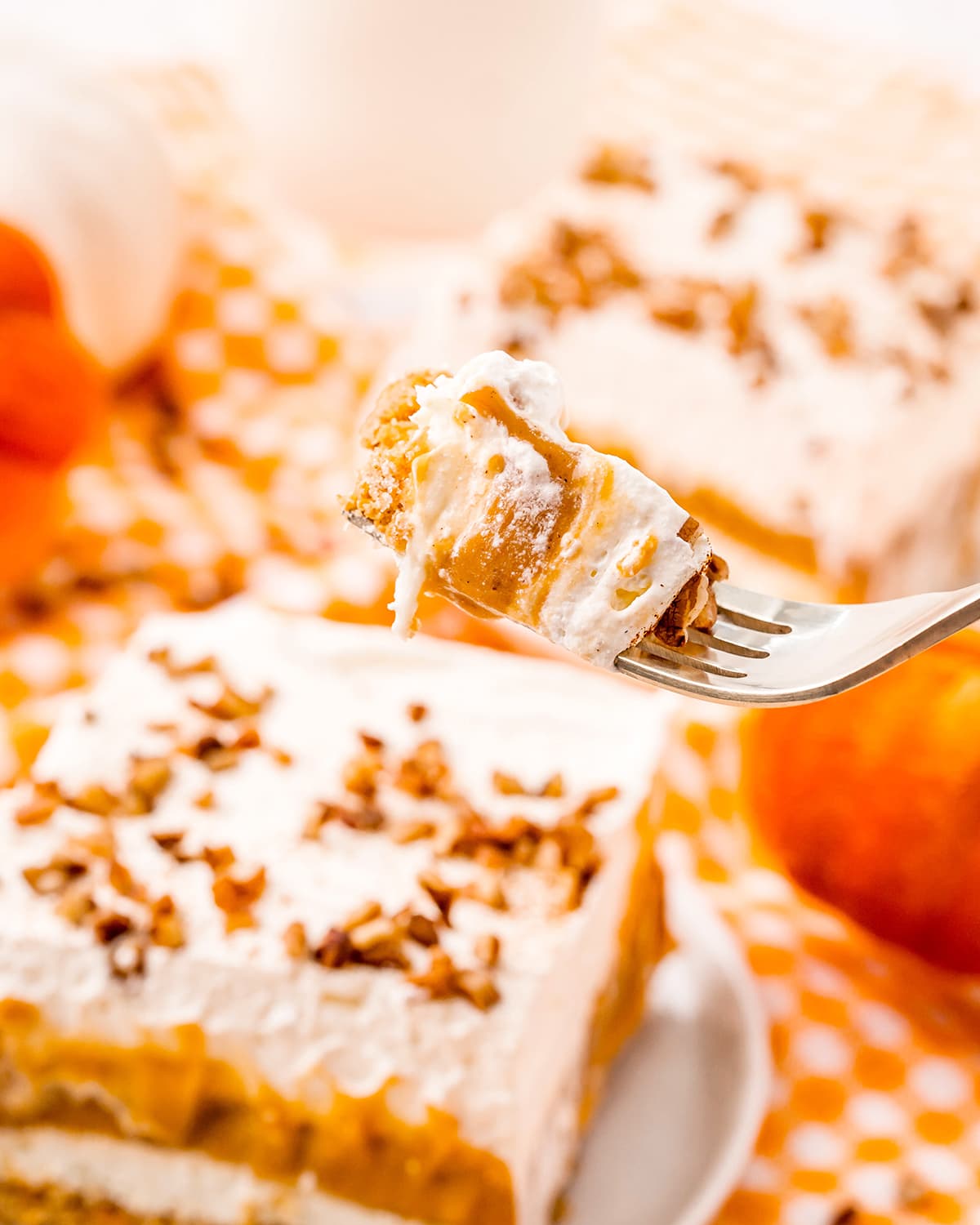 A bite of a pumpkin dessert on a fork.