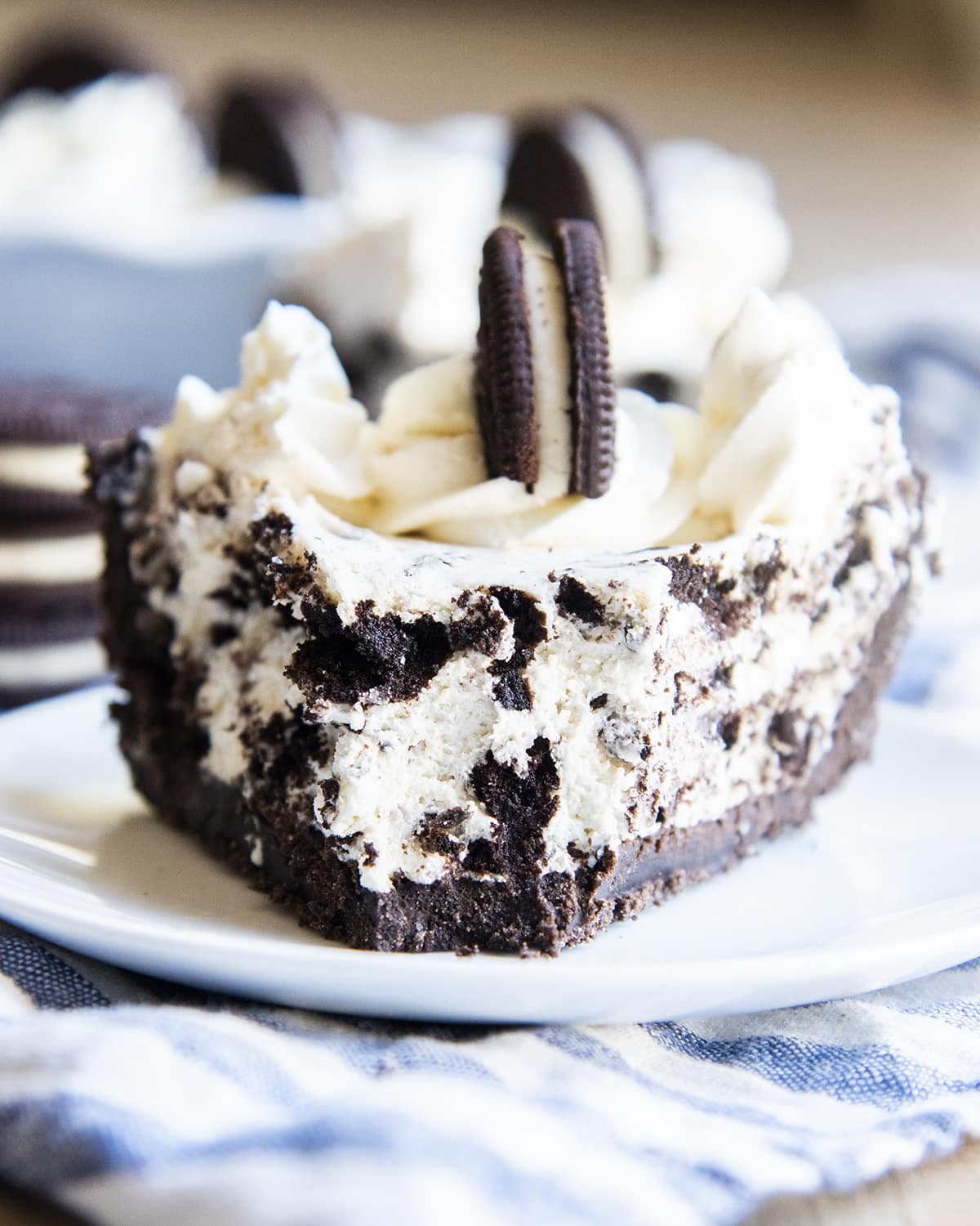 A cookies and cream pie with an Oreo crust, with a bite taken out of the front.