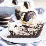 A piece of cookies and cream pie on a plate.