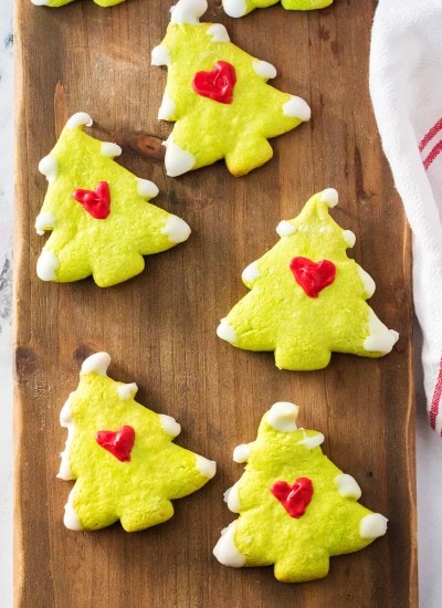 Grinch Christmas Tree Cookies on a wooden board.