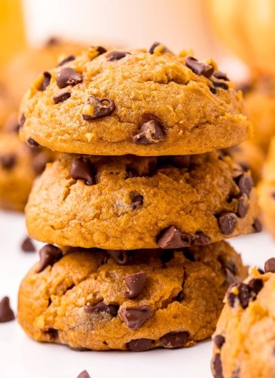 A close up of a stack of pumpkin chocolate chip cookies.