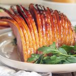 A slow cooker ham covered in a sweet glaze.