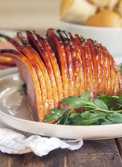 A slow cooker ham covered in a sweet glaze.