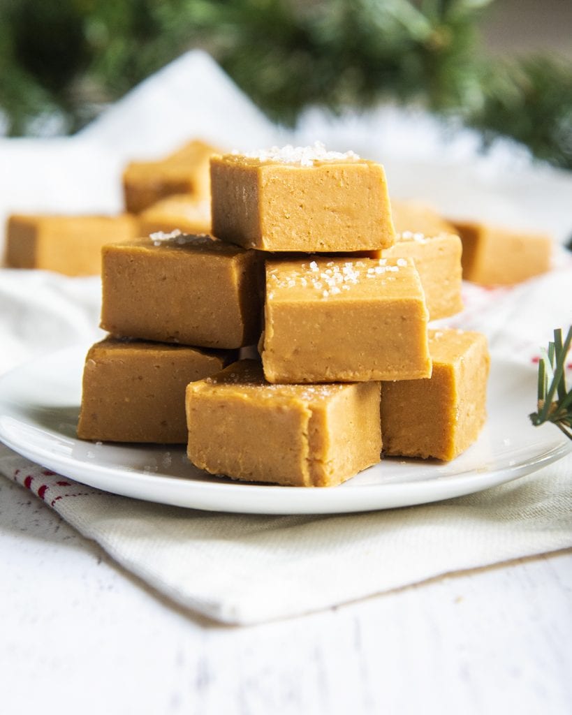 A small plate of caramel fudge stacked in a pile. 