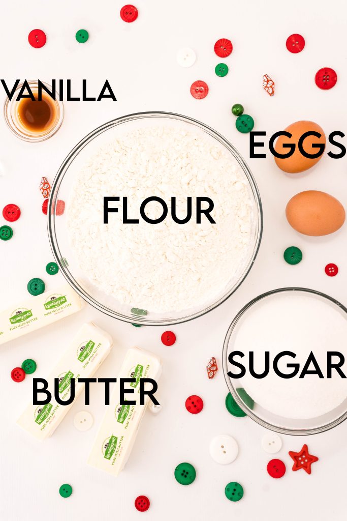 An image of the ingredients needed to make spritz cookies, labeled with text showing what they are: flour, vanilla, eggs, sugar, and butter. 