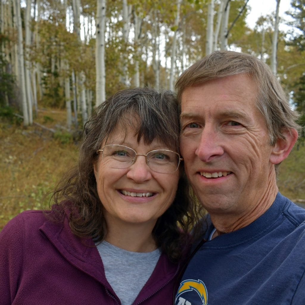 A man and woman smile for a photo.