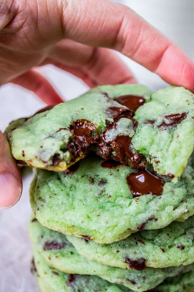 A stack of green mint chocolate chip cookies. 