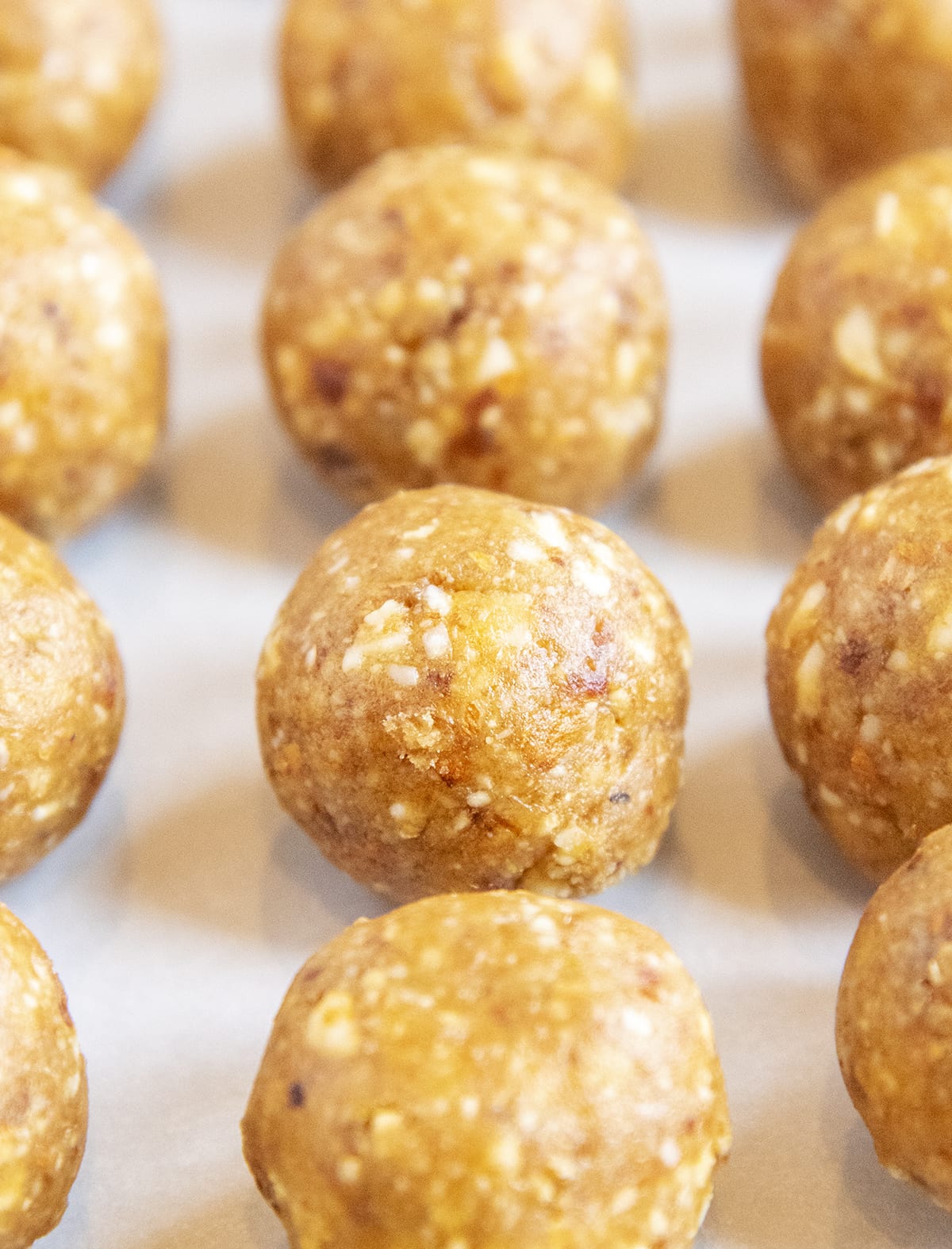 A close up of lemon energy balls lined up in rows.