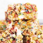A close up of fruity pebbles rice krispie treats in a pile.