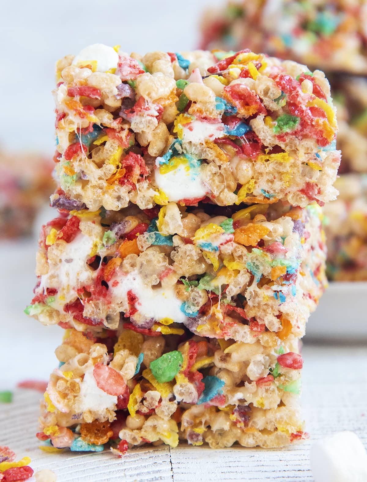 A stack of three fruity pebbles rice krispie treats.