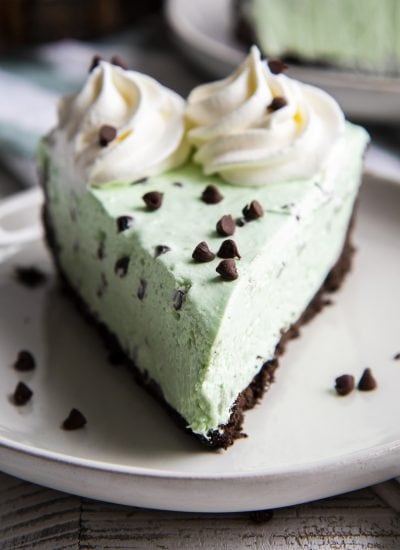 A piece of no bake mint chocolate cheesecake on a white plate.