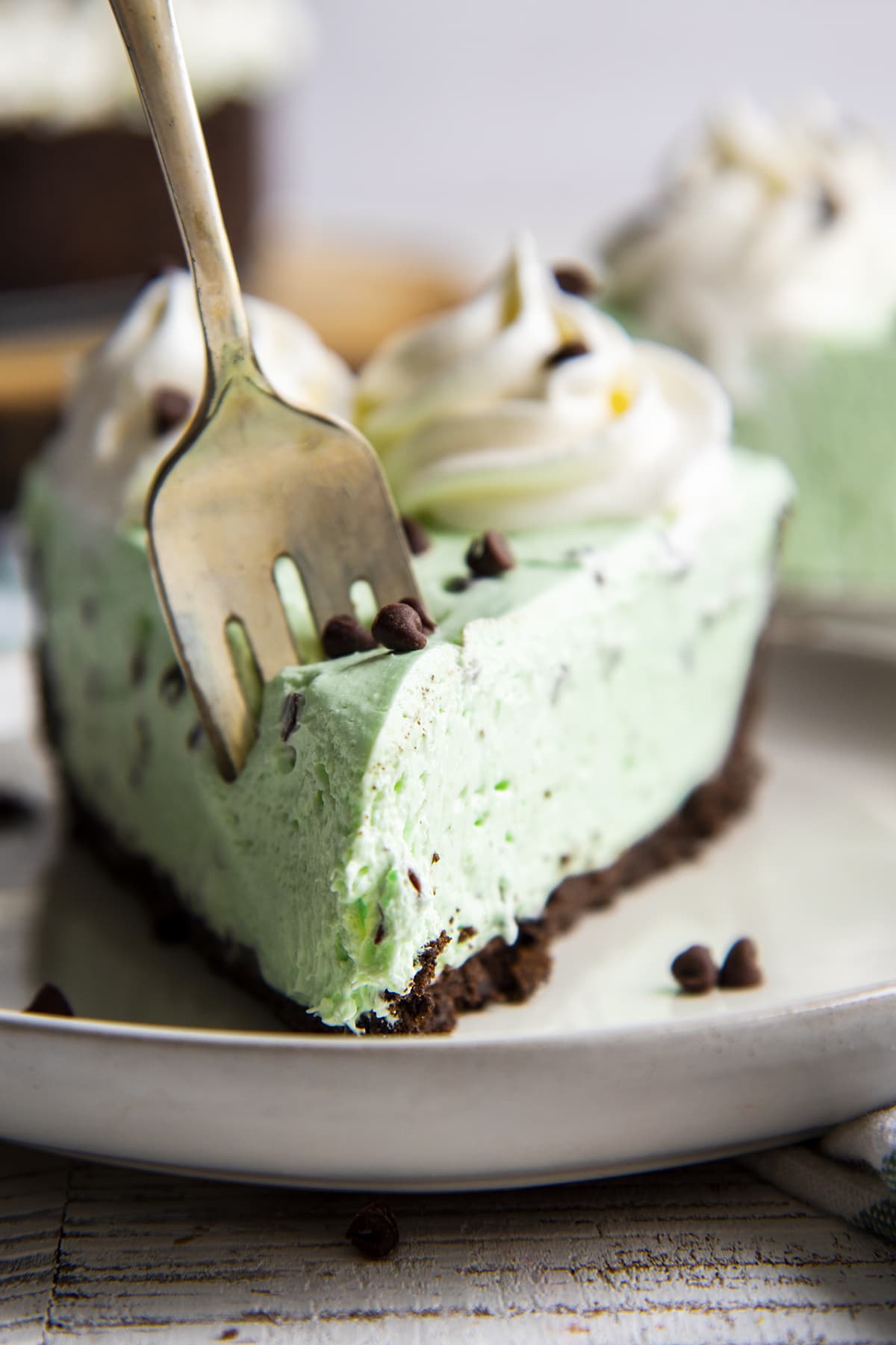 A close up of a piece of mint chocolate cheesecake on a plate.