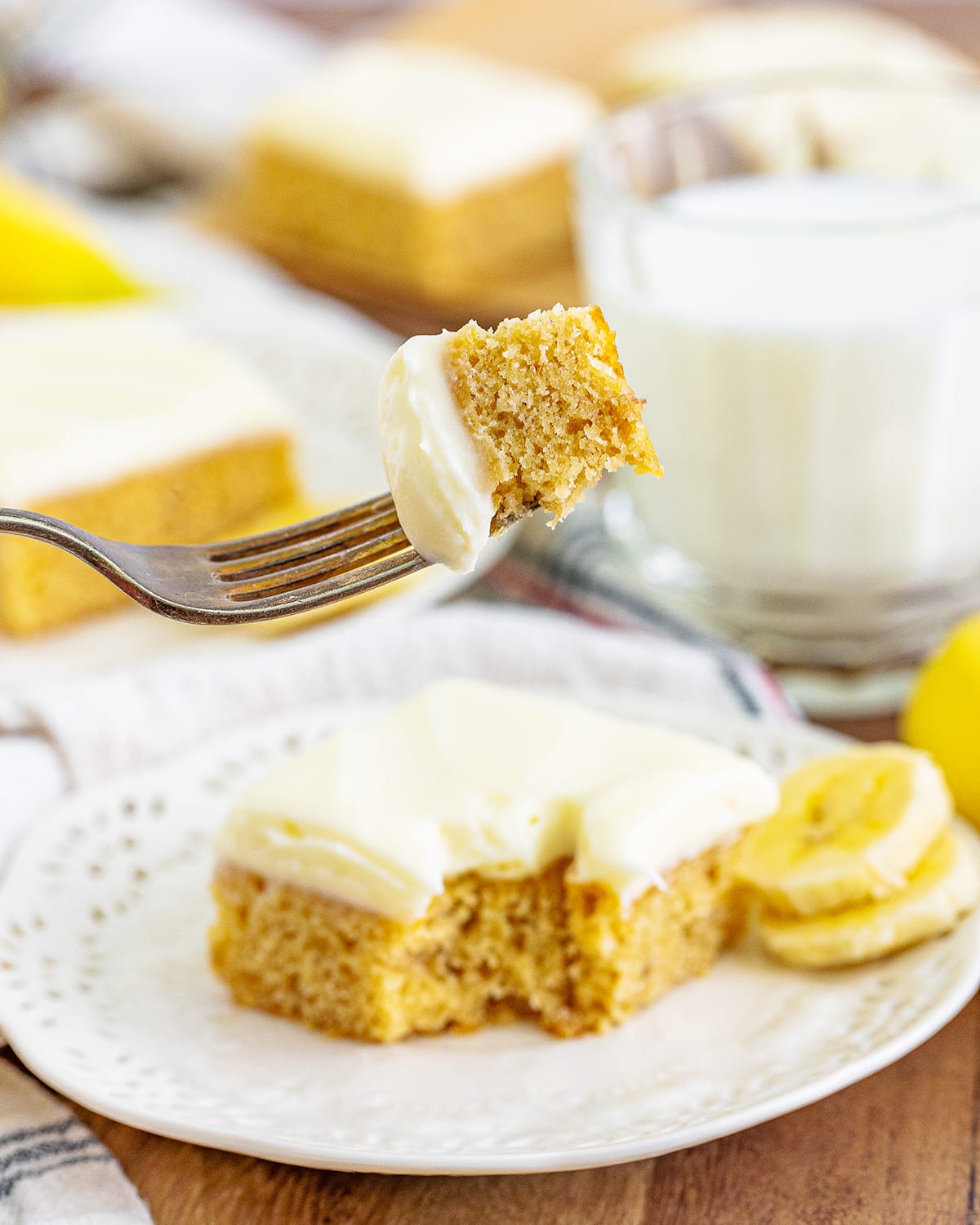 A forkful of banana blondie with cream cheese frosting.