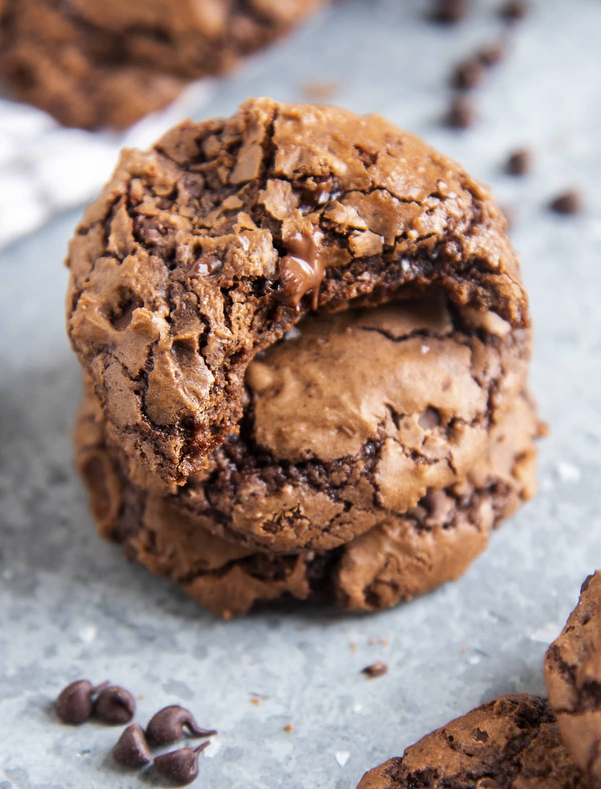 Brownie cookies in a stack. The top cookie has a bite out of it.