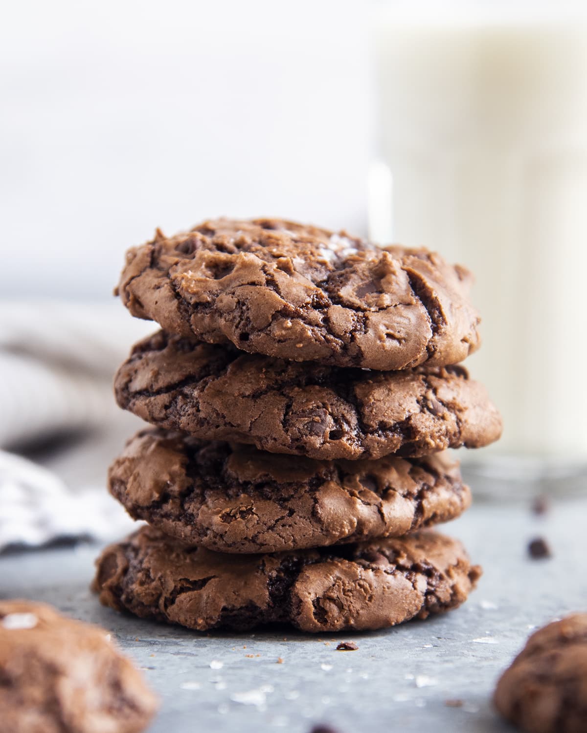 A stack of four chocolate brownie cookies.