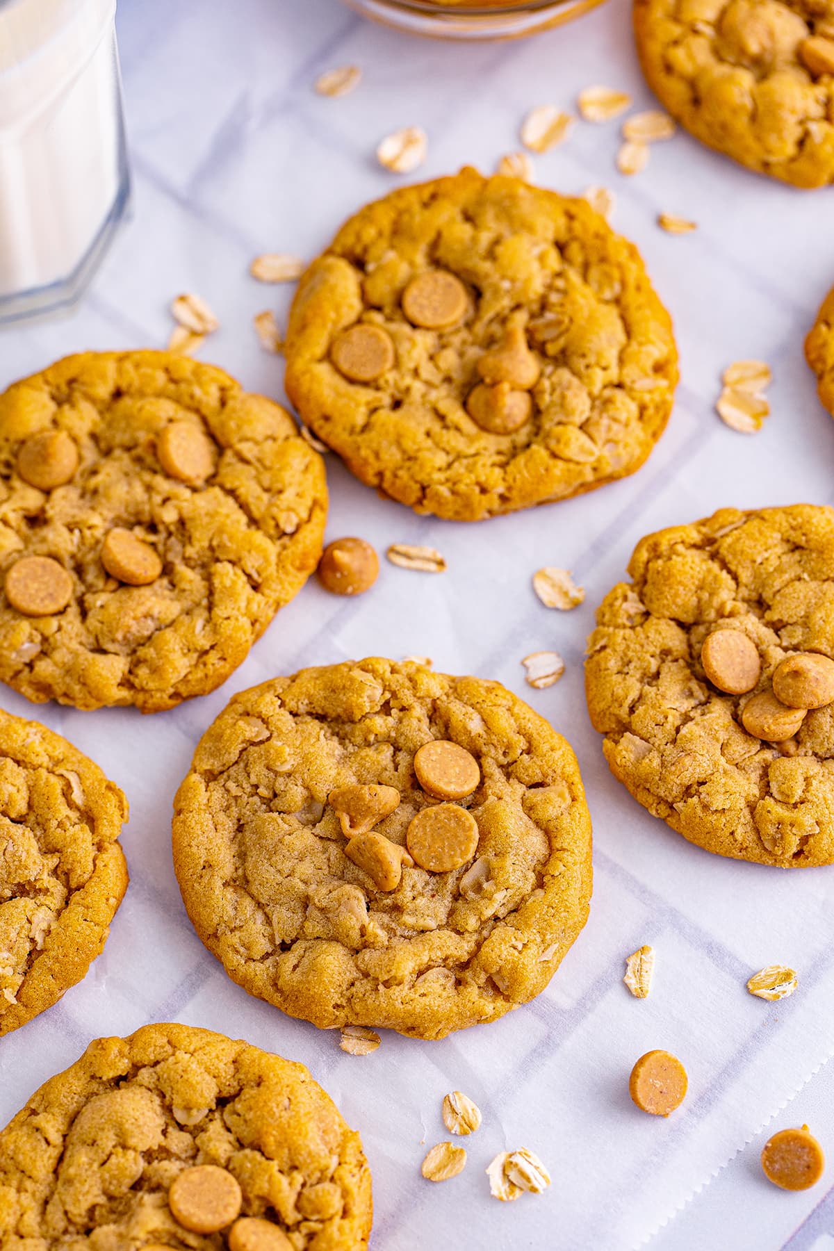 Peanut butter oatmeal cookies on a piece of waxed paper.