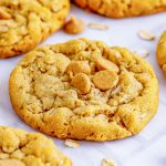 A close up of a peanut butter oatmeal cookie topped with peanut butter chips.