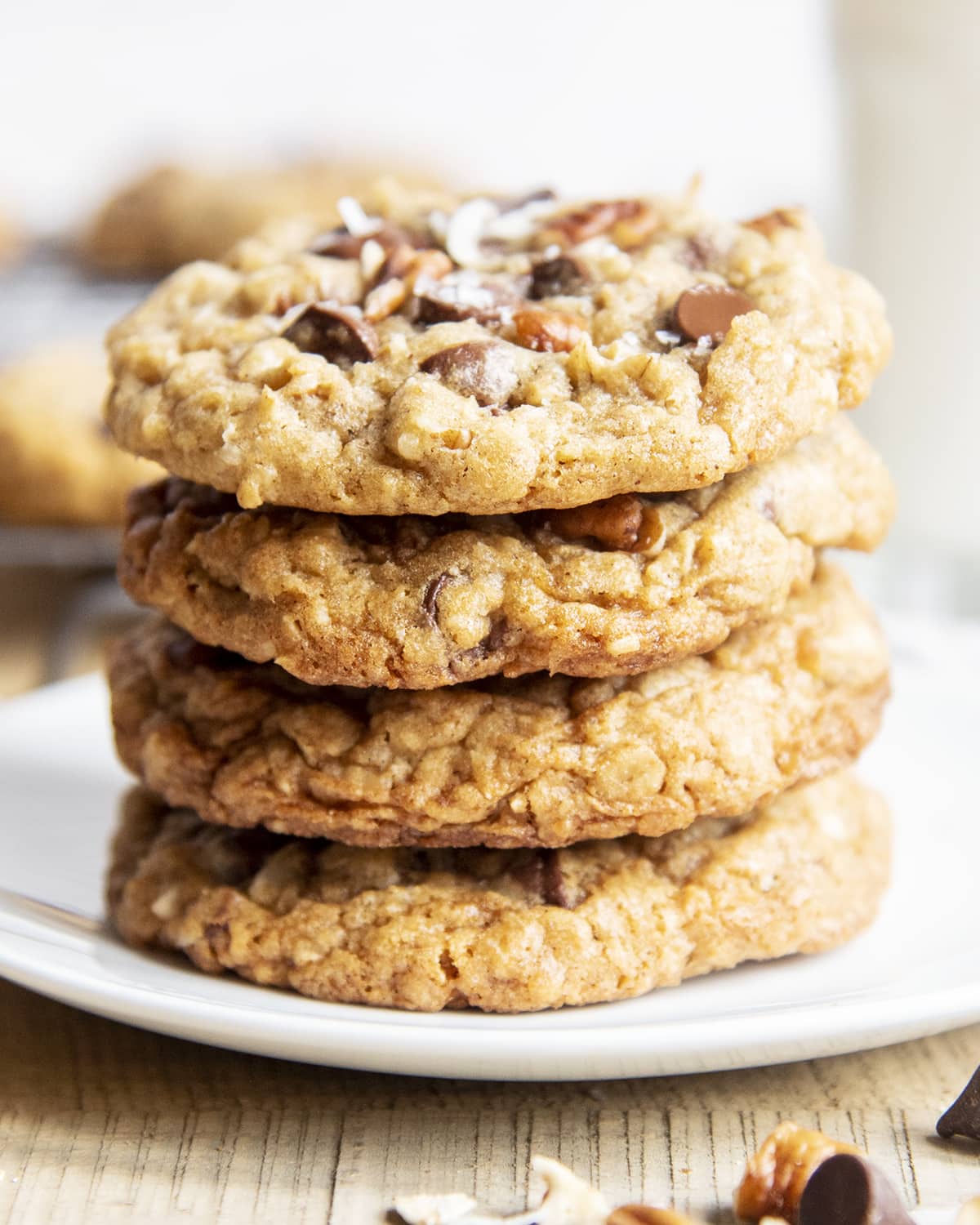 A stack of 4 oatmeal cowboy cookies on a plate.