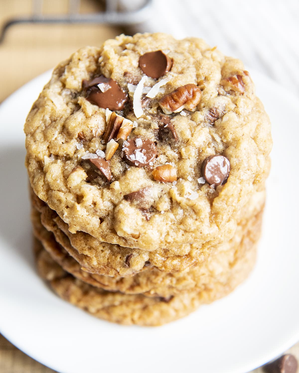 An overhead photo of a stack of oatmeal chocolate chip cookies with pecans and coconut.