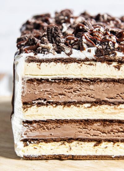 A close up of the inside of an ice cream sandwich cake layered with ice cream sandwiches, and chocolate ice cream.