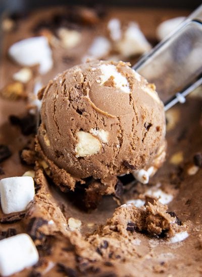 A close up of a scoop of chocolate rocky road ice cream.