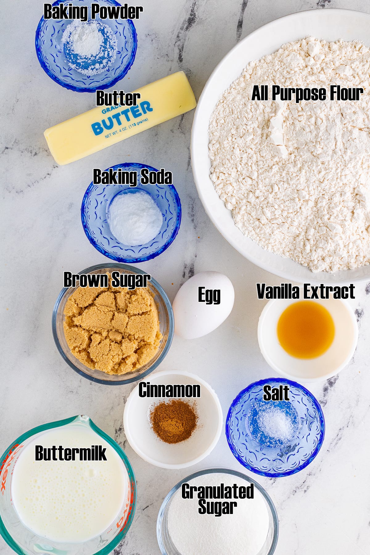 The ingredients needed to make cinnamon quick bread, with each of them labeled.
