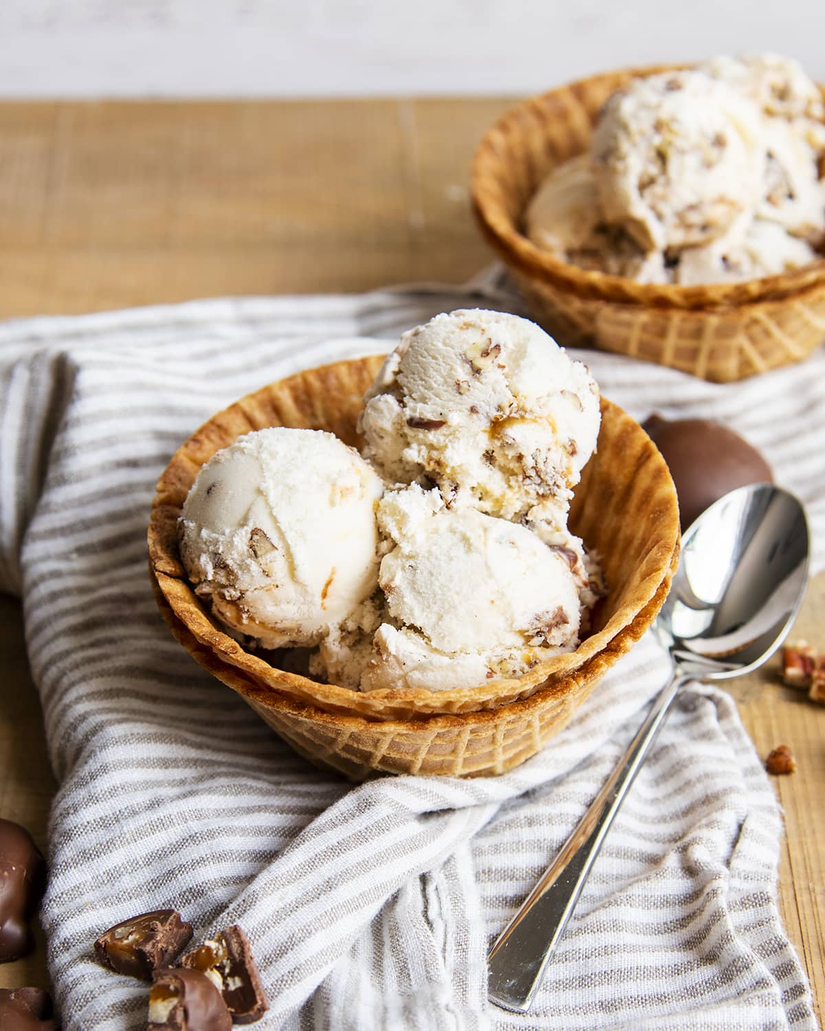 A bowl of vanilla ice cream with caramel swirls.