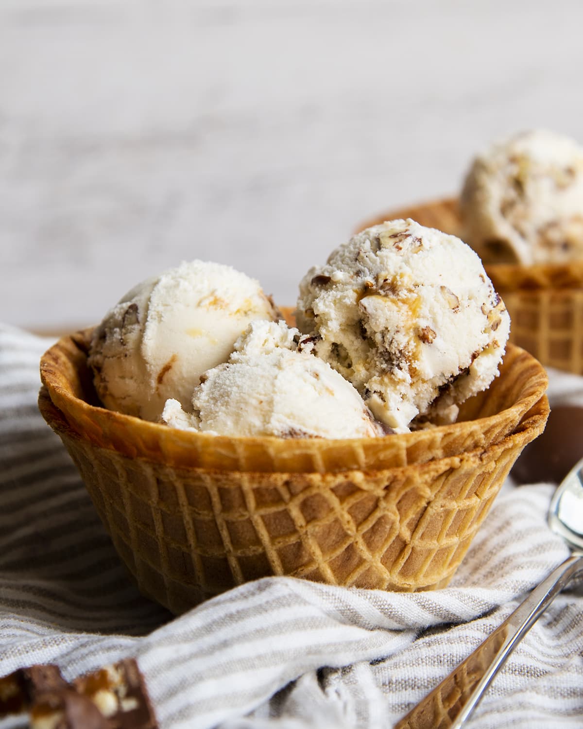 A bowl of turtle ice cream made with a waffle cone bowl.