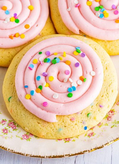 An overhead photo of a pink frosted sprinkle cookie.
