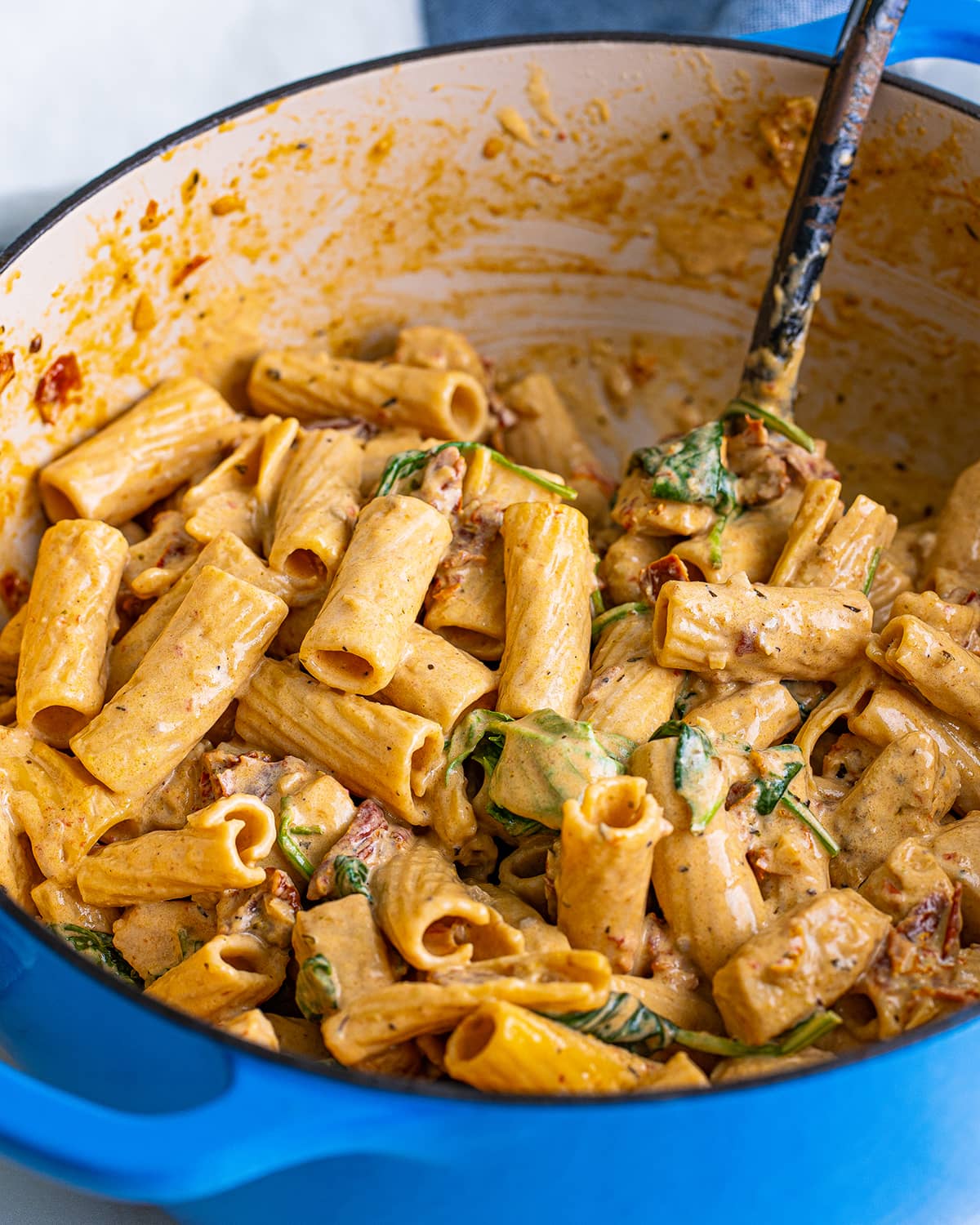 A pot of tuscan chicken pasta made with rigatoni.