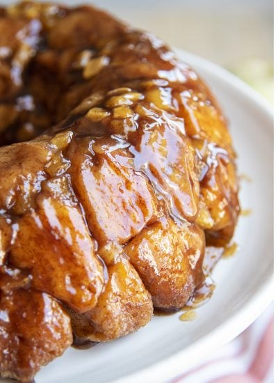 A close up of pieces of a pull apart apple monkey bread on a plate.