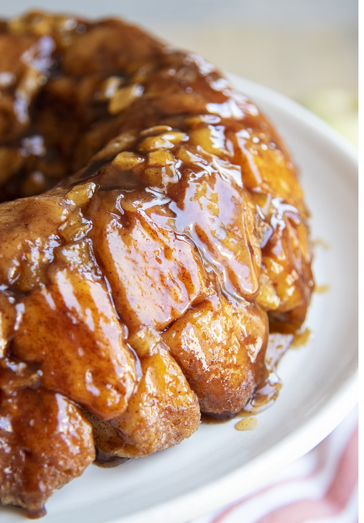 A close up of pieces of a pull apart apple monkey bread on a plate.