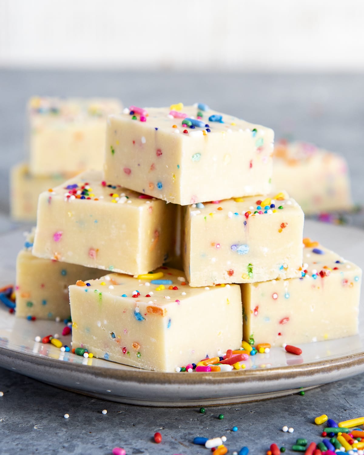 A pile of white chocolate fudge pieces on a plate.