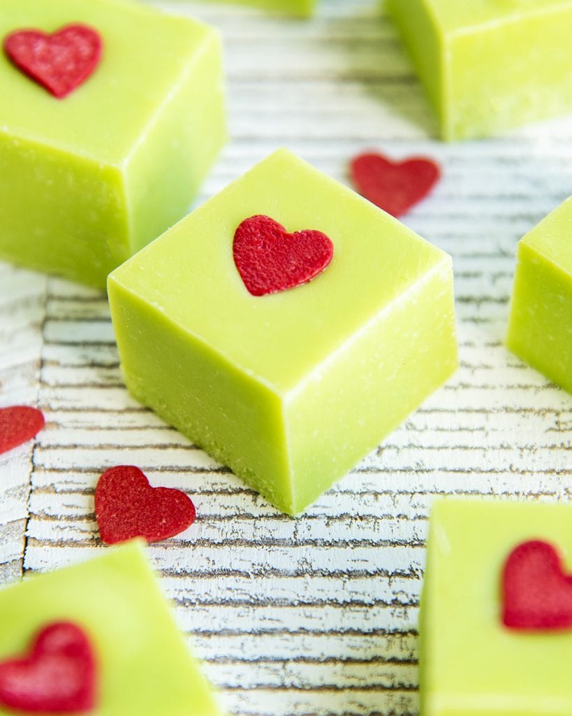 A close up of a piece of green grinch fudge on a white table.
