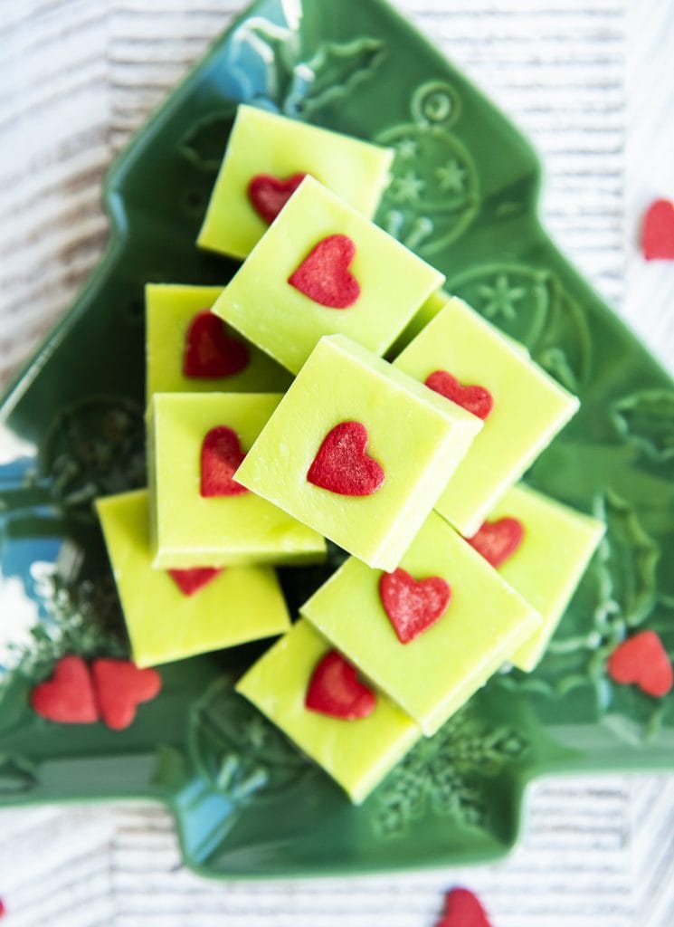 An overhead photo of a pile of green pieces of fudge on a plate.