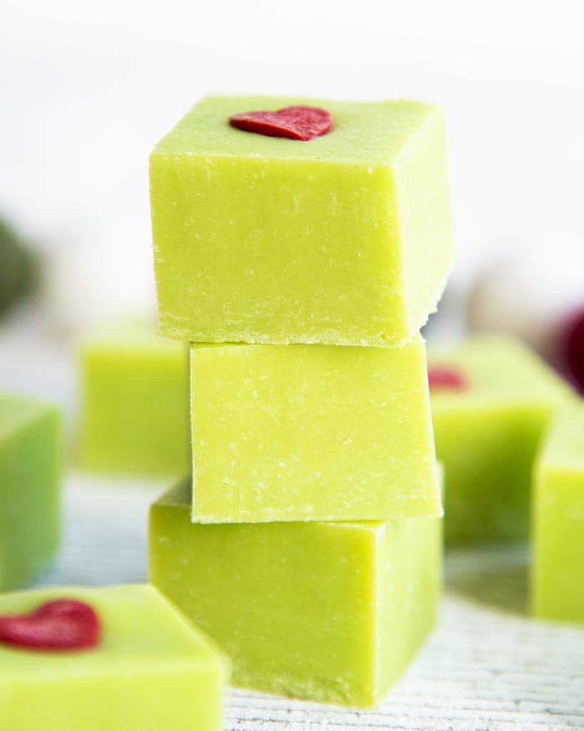 A stack of three pieces of green Grinch fudge.