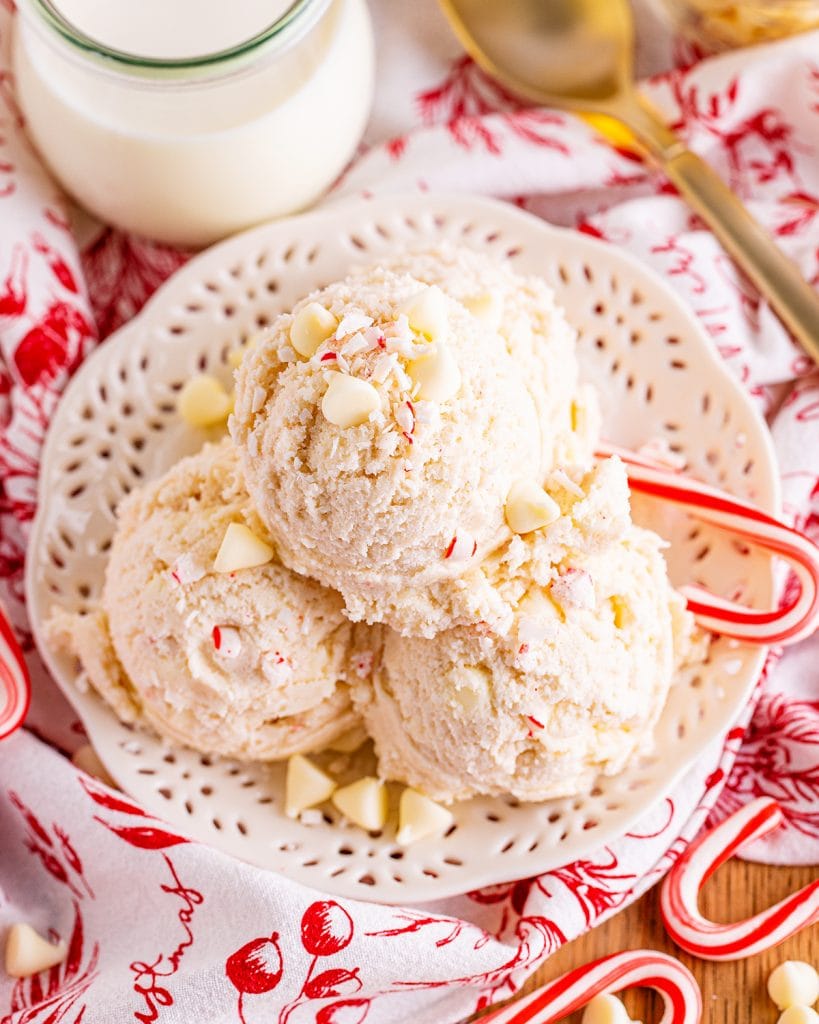An overhead photo of a bowl of peppermint cookie dough topped with white chocolate chips.