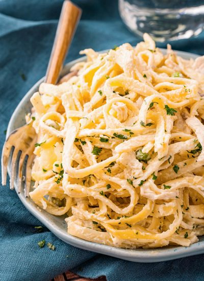 A plate of tetrazzini with a fork next to it.