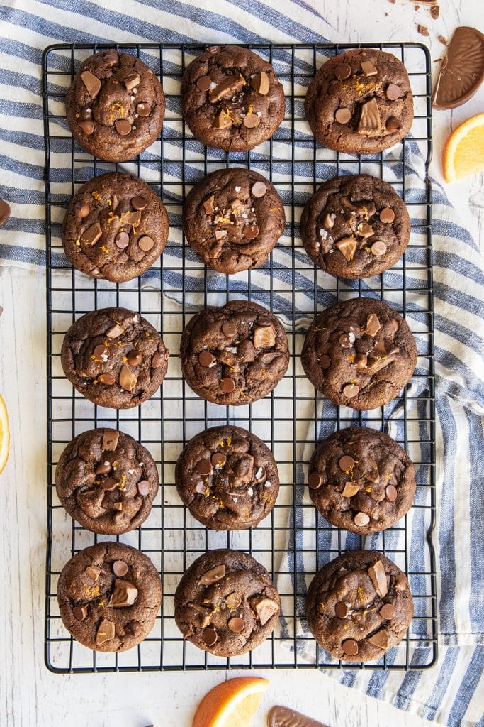 An overhead photo of a cooling wrack topped with rows of chocolate orange cookies.