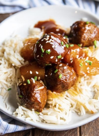 A plate of rice topped with hawaiian meatballs.