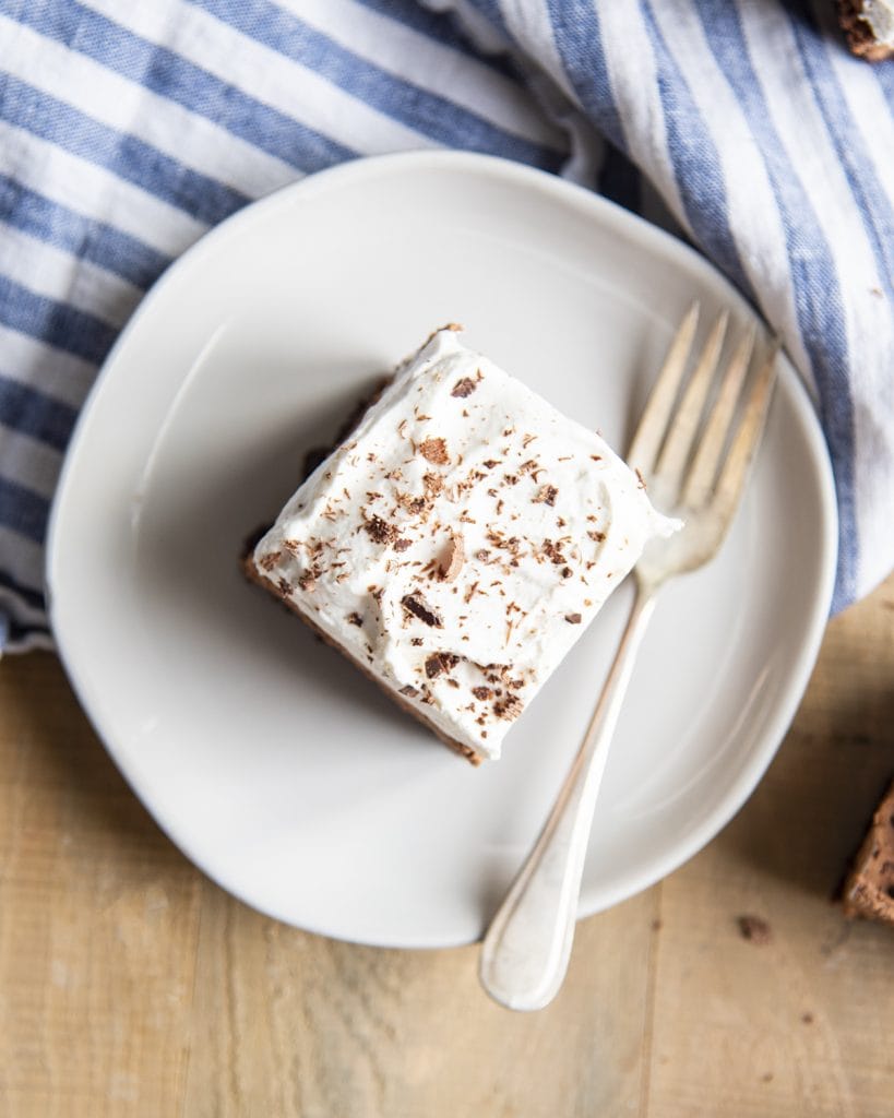 An overhead photo of a whipped cream topped french silk brownie.