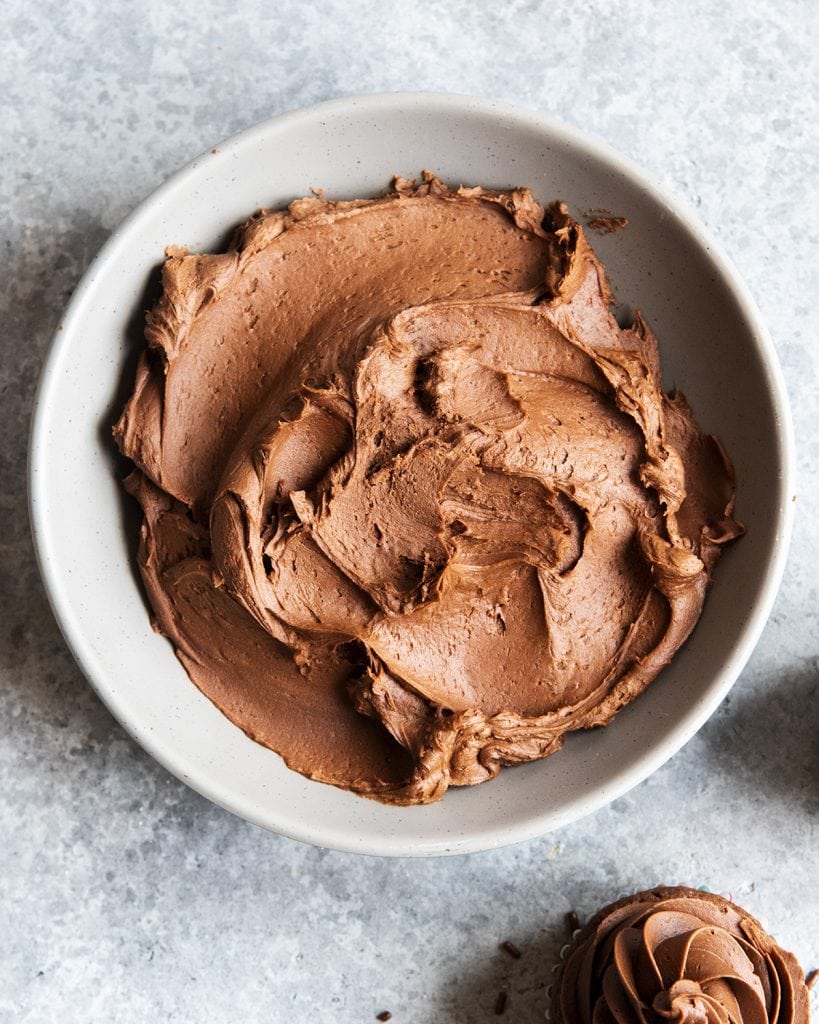 An overhead photo of a bowl of chocolate buttercream frosting.
