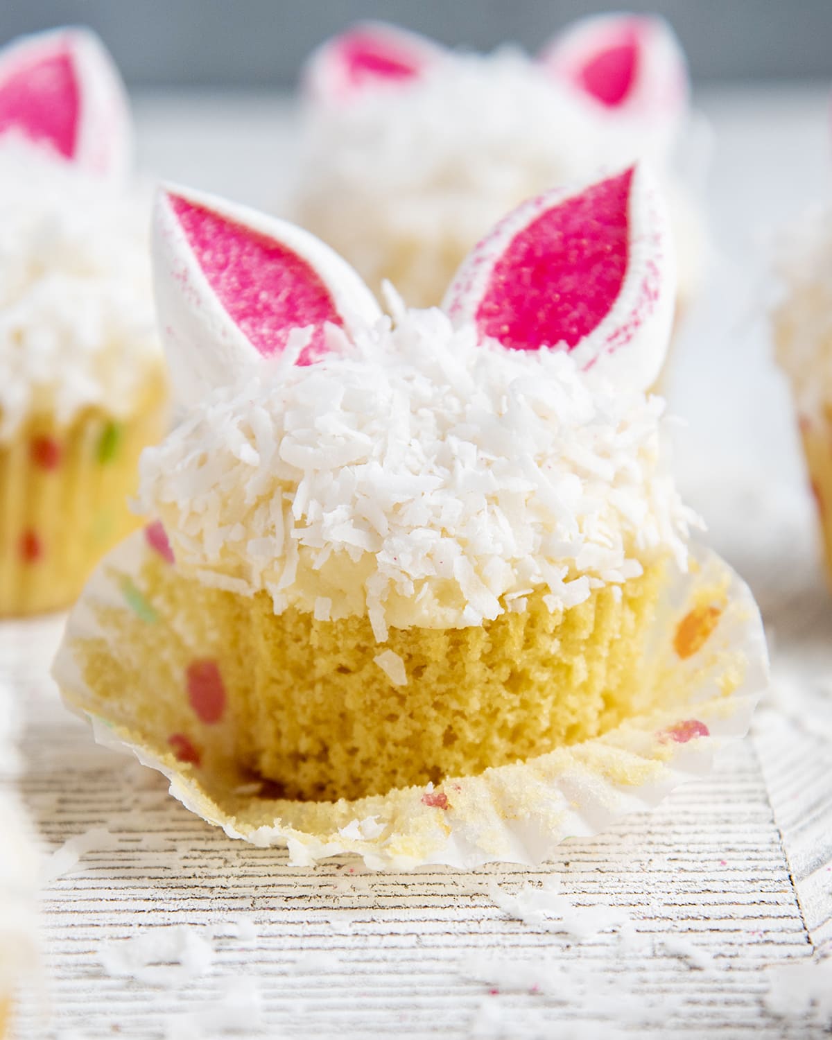 An Easter Bunny Cupcake topped with shredded coconut and marshmallow bunny ears.
