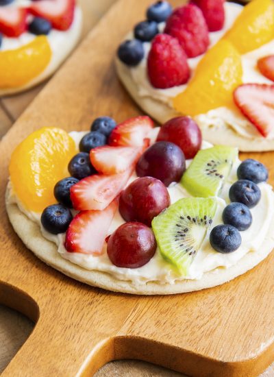 Easter fruit pizza cookies on a wooden board.