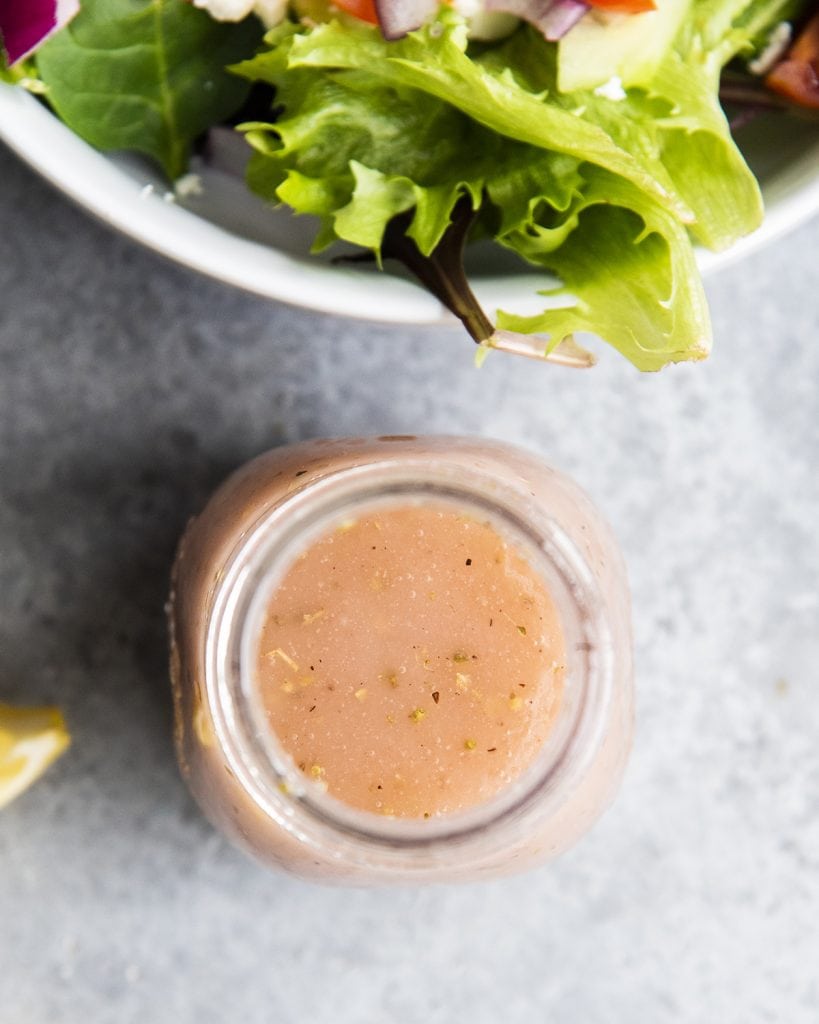 An overhead photo of a bottle of red wine vinaigrette salad dressing.