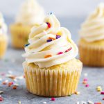 Vanilla Cupcakes topped with buttercream frosting and sprinkles.