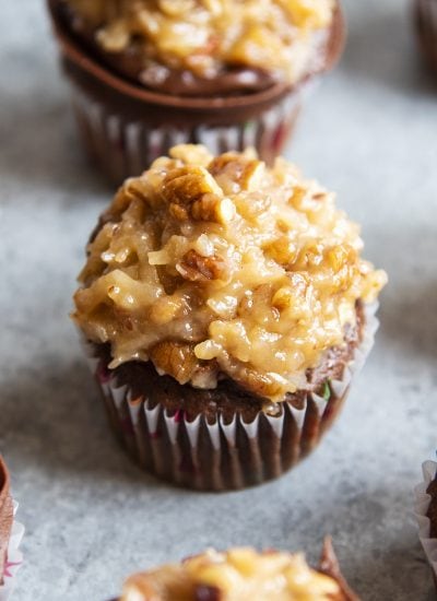 A chocolate cupcake topped with coconut pecan frosting.