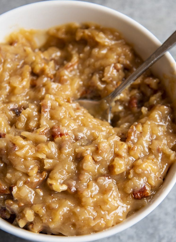 A close up of a bowl of coconut pecan frosting.