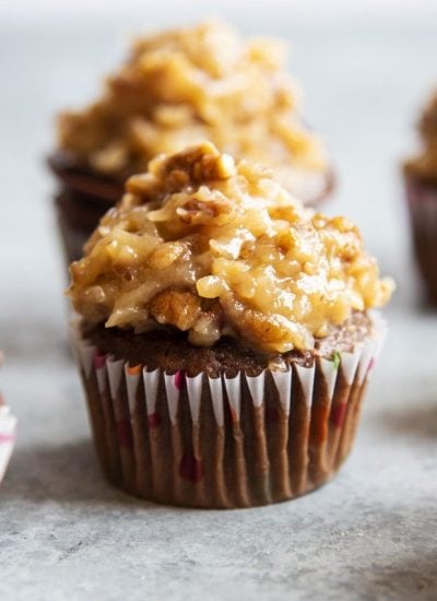 A chocolate cupcake topped with a pile of German chocolate cake frosting.